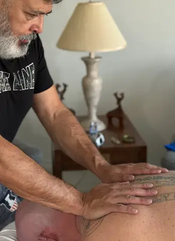 Therapist performing deep tissue massage on shoulders